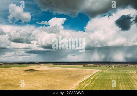 Aerial View. Amazing Natural Dramatic Sky With Rain Clouds Above Countryside Rural Field Landscape In Spring Summer Cloudy Day. Scenic Sky With