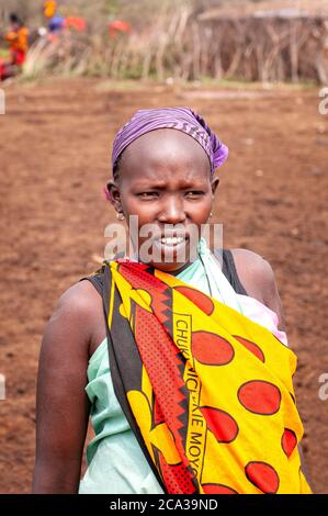 Maasai woman, wearing traditional attire, in a maasai village. Maasai Mara National Reserve. Kenya. Africa. Stock Photo