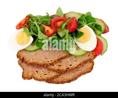 Thin slices of haslet meat with a fresh egg salad meal isolated on a white background, haslet is an English pork and herb meatloaf Stock Photo