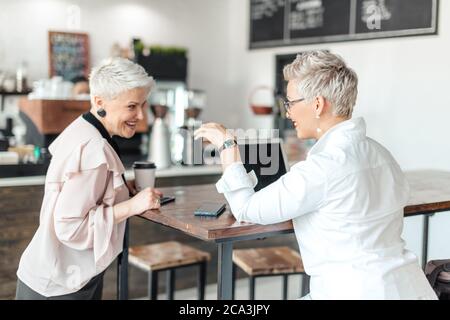 business woman and client discussing possible contract indoor Stock Photo
