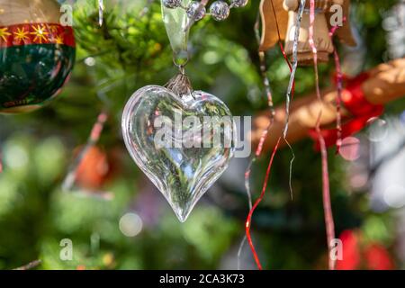 A heart shaped Christmas decoration hanging on a Christmas tree Stock Photo