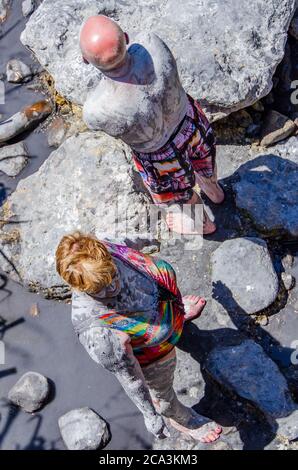 Woman and man covered in mud at the Sulphur Springs in St. Lucia Stock Photo