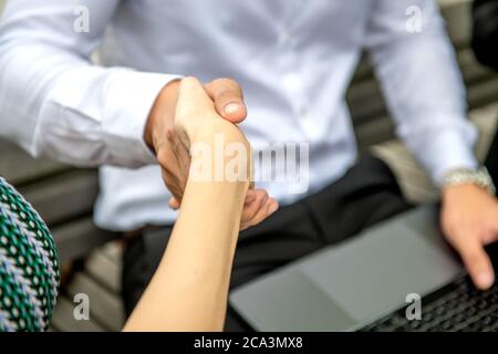 Business handshake between man and woman. Stock Photo
