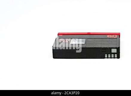 side view of a Mini DV format video cassette isolated on a white background. MiniDV cassettes had been intended for amateur use, Stock Photo