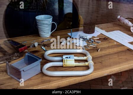 desktop in the workshop, tools lie on the table in the workshop. workshop table behind glass Stock Photo