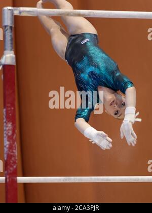 Professional athlete performs an exercise in the gym. Pulls the bar to ...