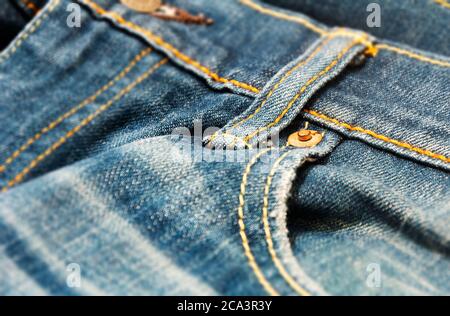 close-up view of the copper rivet on the pocket of a pair of denim trousers. Casual and workwear. Denim fabric for jeans trousers Stock Photo