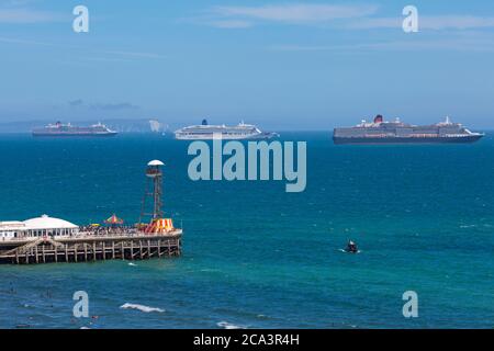 Queen Elizabeth, Aurora, Queen Victoria, 3 cruise ships anchored in Poole Bay at Bournemouth, Dorset UK in August during Coronavirus Covid 19 pandemic Stock Photo