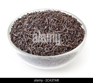 Dry black tea in glass bowl isolated on white background with clipping path Stock Photo