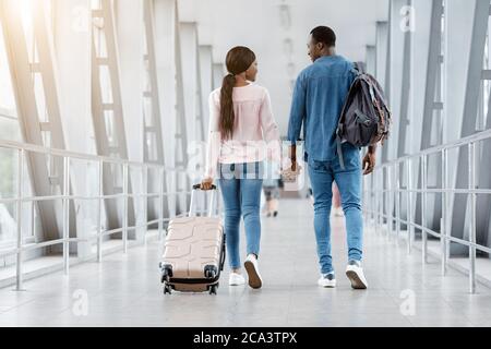 Romantic Black Couple Walking With Suitcases In Airport Terminal ...