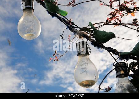 Portland. 4th August 2020. UK Weather. Early morning sunshine silhouettes garden ornaments in Fortuneswell, against an already blue sky. Credit: stuart fretwell/Alamy Live News Stock Photo