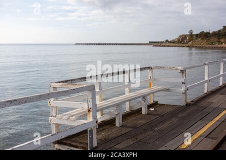 A bench seat on the Granite Island Causeway looking towards to granite island located in Victor Harbor South Australia on August 3 2020 Stock Photo