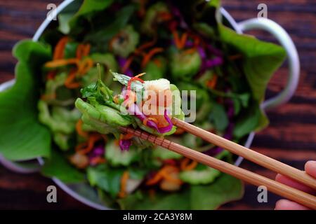 bitter melon salad with violet cabbage, carrot, fried bread, peanut with basil, sour mixed vegetable for vegan cuisine, diet dish for healthy eating Stock Photo