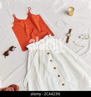 woman is going to pack her clothes for travelling. top view photo. trip concept. discounts on summer clothes Stock Photo