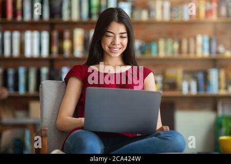 Smiling Asian Student Girl Preparing For Exam With Laptop At Library Stock Photo