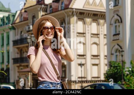 Beautiful Young Woman tourist in the City Center talking on the phone Stock Photo