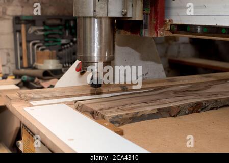 Woodwork cnc machine working on wood board. Machine tool at the wood factory. Stock Photo