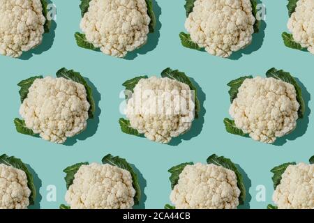 Pattern with cauliflower. Vegetables abstract background. Cauliflower on turquoise blue background. Stock Photo