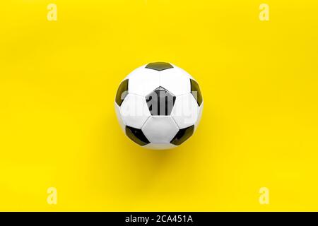 Football ball on yellow background top view copy space Stock Photo