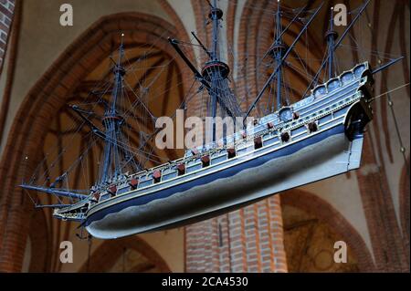 Sweden, Stockholm. English Galleon, 16th century. Votive ship hanging from the ceiling of the Cathedral of Saint Nicholas. One of the oldest votive ships in the world. This ship model is a copy of the original made in 1950s. The original ship model was built around 1600, today kept in the Museum of Maritime History in Stockholm. The ship-type is an Elizabethan galleon, as at the end of the 15th century.