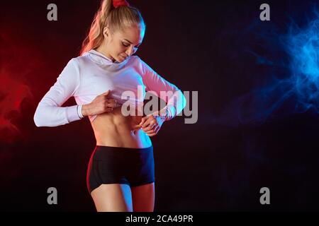 good looking fit girl checking her cellulite. weight loss, diet concept. healthy lifestyle. copy space . isolated black background Stock Photo