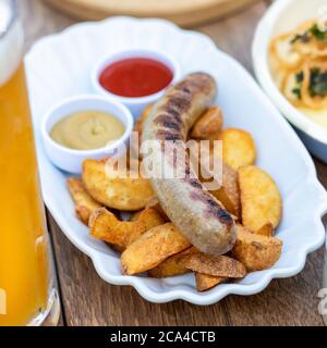 German sausage with fried potato, ketchup close up Stock Photo