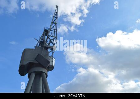 Old unused crane against the blue partially cloudy sky Stock Photo - Alamy