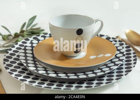 Set of clean tableware, dishes, plates, utensils on the table Stock Photo