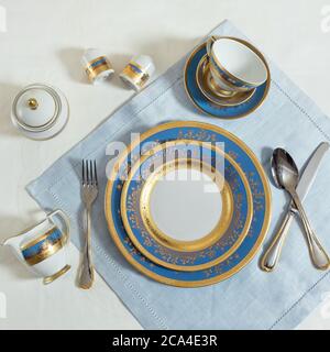 Set of clean tableware, dishes, plates, utensils on the table Stock Photo