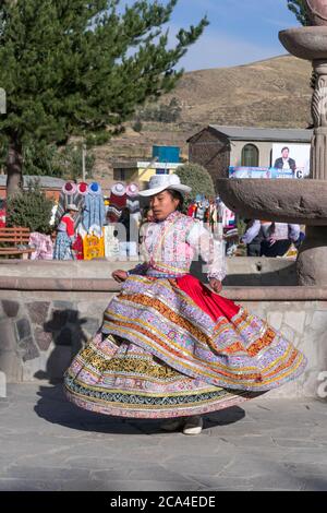 Chivay, Peru - september 26, 2018: A group of young ethnic Peruvian dancers wearing traditional Peruvian dresses in the town square of Chivay, Peru. Stock Photo