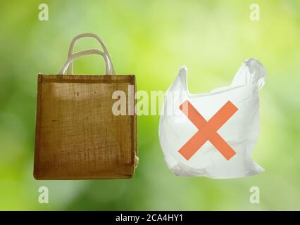 fabric and plastic bag optional for environment concern on green background Stock Photo
