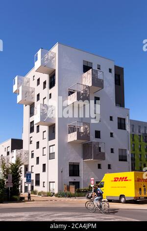 the Kubikon quarter of the GAG Immobilien AG in the Ehrenfeld district of Cologne, DHL parcel service car, Germany.  das Stadtquartier Kubikon der GAG Stock Photo