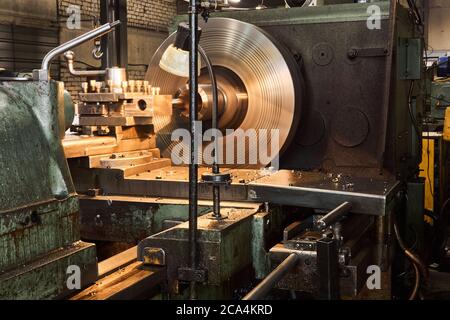 machining a workpiece of a part on a lathe close-up, some parts are blurred in motion Stock Photo