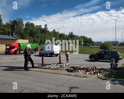 Stockholm. 4th Aug, 2020. Local people gather and mourn near to the site where a 12-year-old girl was killed after being hit by a stray bullet in a gang shooting at a petrol station car park in Norsborg, south of Stockholm, Sweden, Aug. 4, 2020. Sweden's Minister for Home Affairs Mikael Damberg vowed on Tuesday to tackle gang-related crimes following the recent tragic death of a 12-year-old girl. According to Swedish Television, the shooting was part of an escalating conflict between gangs fighting over local drug markets. Credit: Xinhua/Alamy Live News Stock Photo