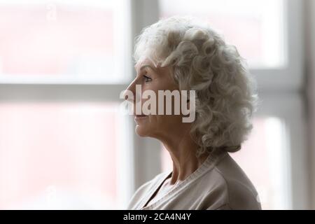 Side profile view face of elderly serious grey haired woman Stock Photo