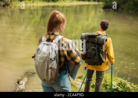 two tourists walking on the forest, enjoying wonderful landscape. back view photo. tourism Stock Photo
