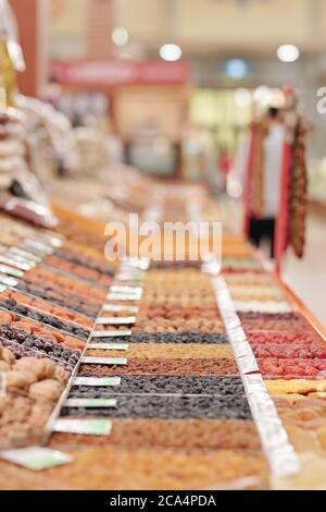 Dried fruits counter with various snacks at modern organic food market, quality products concept Stock Photo