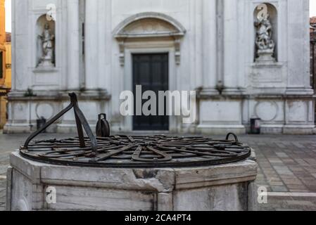 Detail of the wrought iron of a drinking water well in Venice in the courtyart of a church Stock Photo