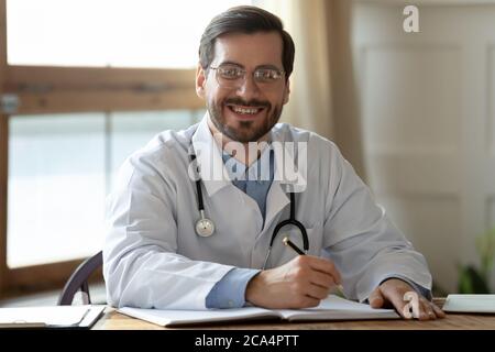 Portrait of smiling young handsome male general practitioner. Stock Photo