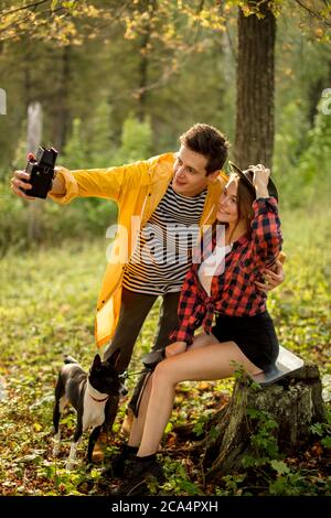 romatic couple taking picture of themselves in the fores with amazing nature. green forest in the background of the photo Stock Photo