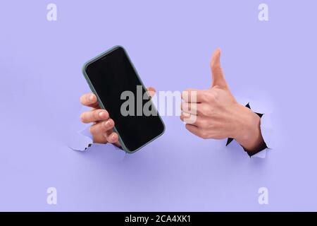 Like and smartphone. Copy space on the smartphone screen, in trendy blue. Stock Photo