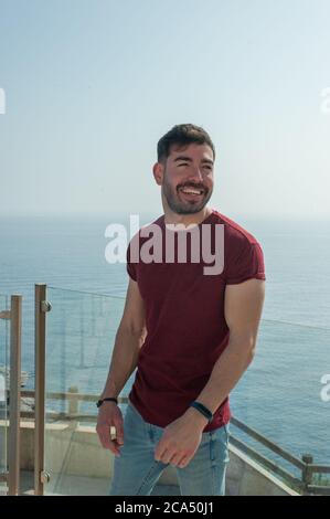 Young man portrait ocean background summer time Stock Photo