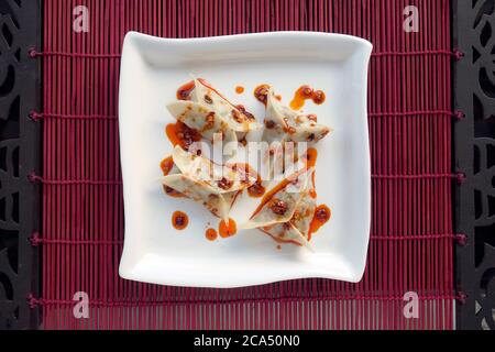 VEGETARIAN DIM SUM  WITH CHILLI OIL AND SCHEZWAN SAUCE Stock Photo