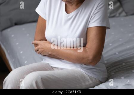 Elderly woman woke up suffers from abdominal pain Stock Photo