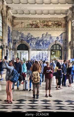 PORTO, PORTUGAL - MAY 24, 2018: People visit Sao Bento Station in Porto, Portugal. The railway station dates back to 1864 and is one of main train sta Stock Photo