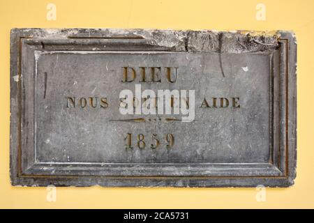 France, Aisne, Guise, Familistere, museum Godin stoves, wall plaque with Dieu Soit nous en aide 1859 Stock Photo