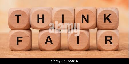think fair printed on wooden cubes Stock Photo