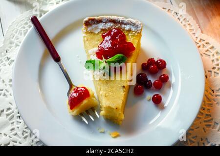 Halloween pumpking cake with cranberry cream on a plate. Food photography Stock Photo