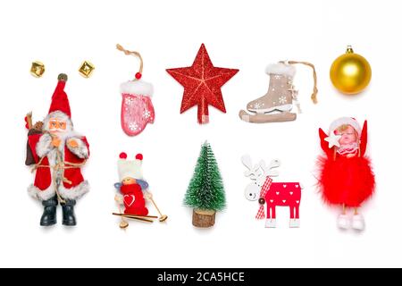 Christmas tree, angel toy, girl skiing, Santa Claus, mitten, star, deer, skates, bells isolated on white background Creative flat lay composition Stock Photo