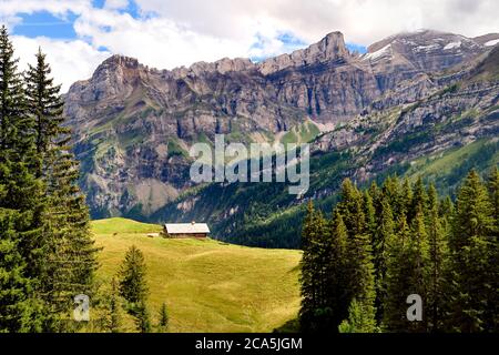 Switzerland, Canton of Vaud, Ormont-Dessus, Les Diablerets, farm to the Lake Retaud above the Col du Pillon and the Schluchhorn mountain in the background Stock Photo